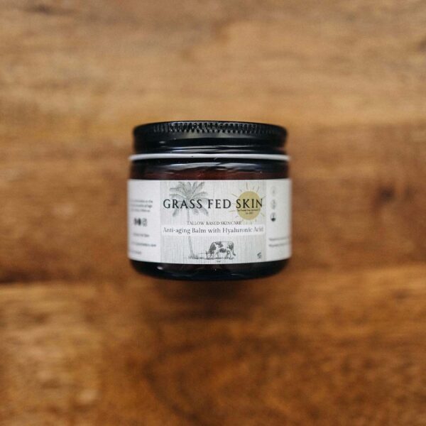 Grass Fed Skin Hyaluronic Acid Anti-Aging Tallow Cream on wood table.